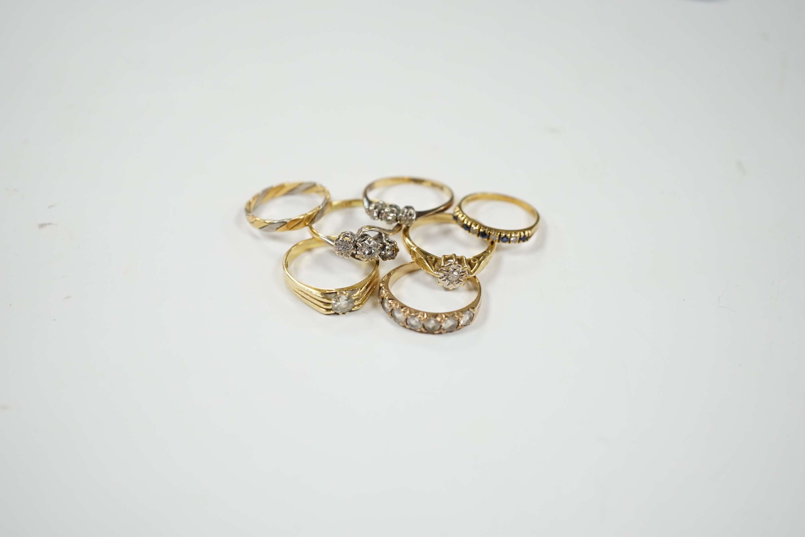 A 1920's 18ct gold and claw set solitaire diamond ring, size O, five other assorted 18ct gold and gem set rings including diamond, together wit a yellow metal and paste set half hoop ring, gross weight 17.2 grams.